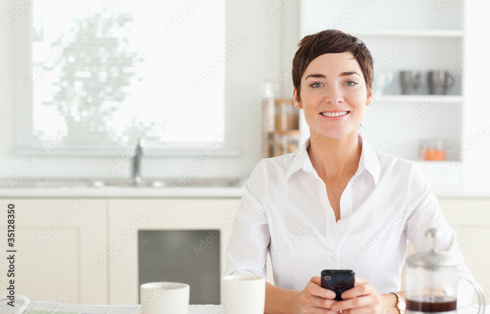 Woman with phone and coffee looking to camera Woman with phone and coffee looking to camera