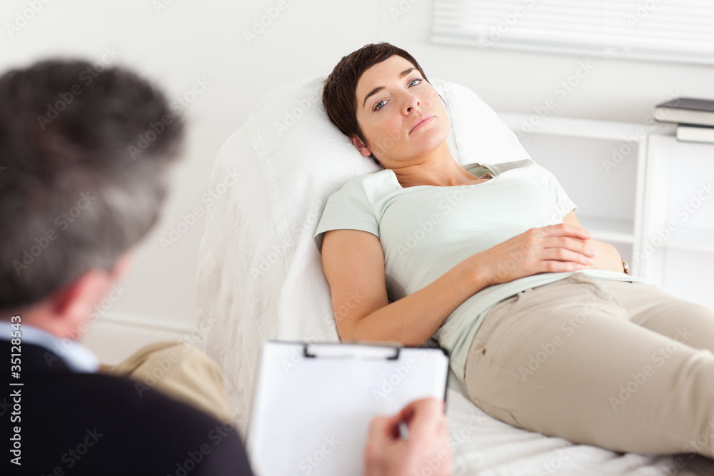 Psychologist talking to a depressed female patient Psychologist talking to a depressed female patient