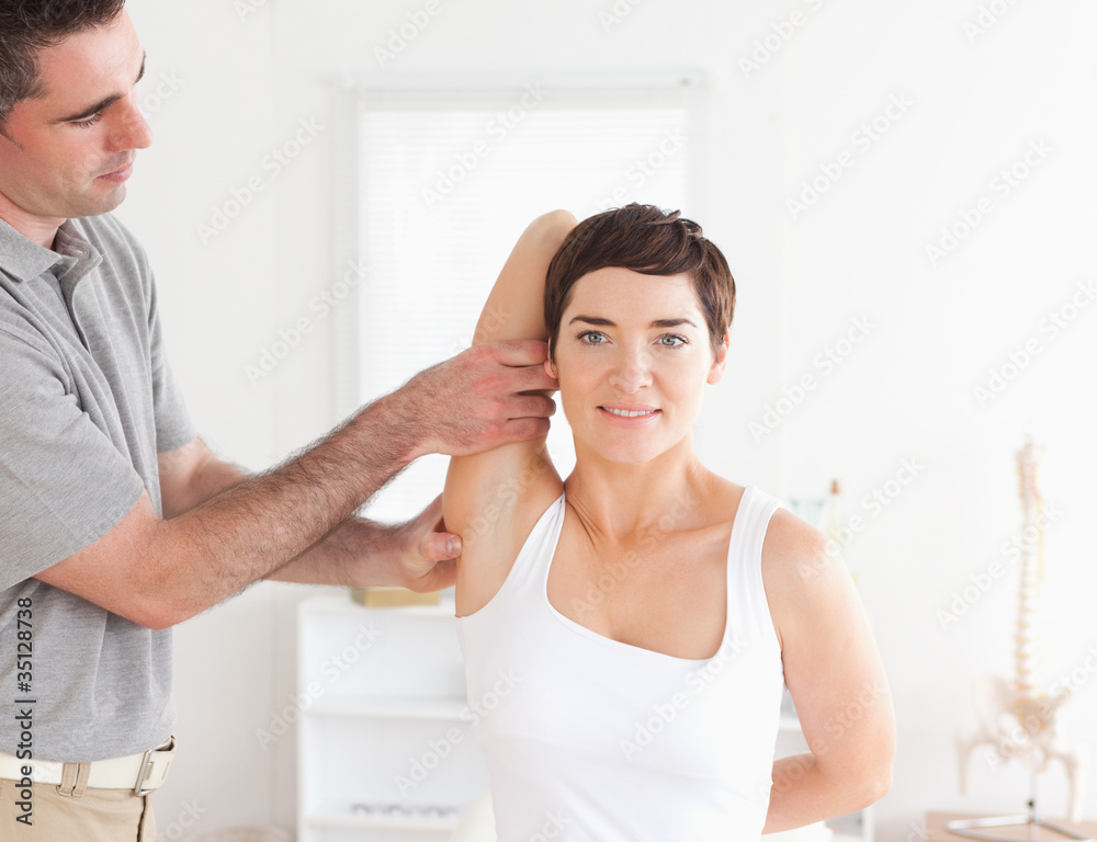 Fototapeta premium Smiling Patient doing some exercises under supervision