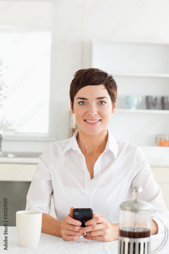 Pretty woman with mobile phone and coffee Pretty woman with mobile phone and coffee