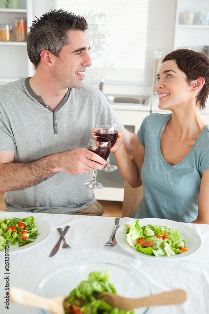 Close up of a Happy couple toasting with redwine Close up of a Happy couple toasting with redwine