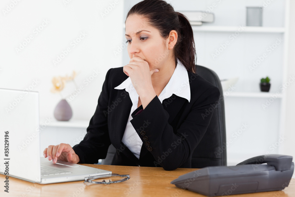 Serious young businesswoman in office Serious young businesswoman in office