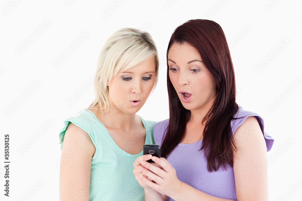 Shocked young women with a cellphone Shocked young women with a cellphone