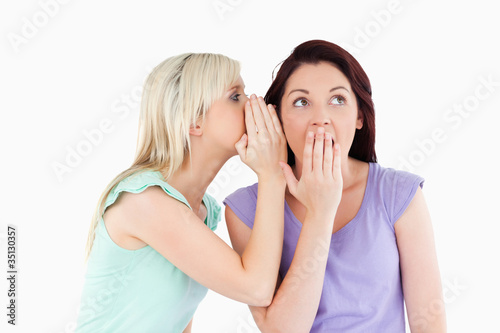Portrait of a gorgeous woman telling her friend a secret