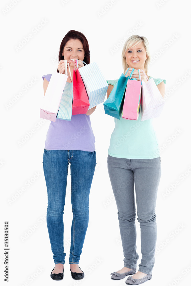 Charming women with shopping bags