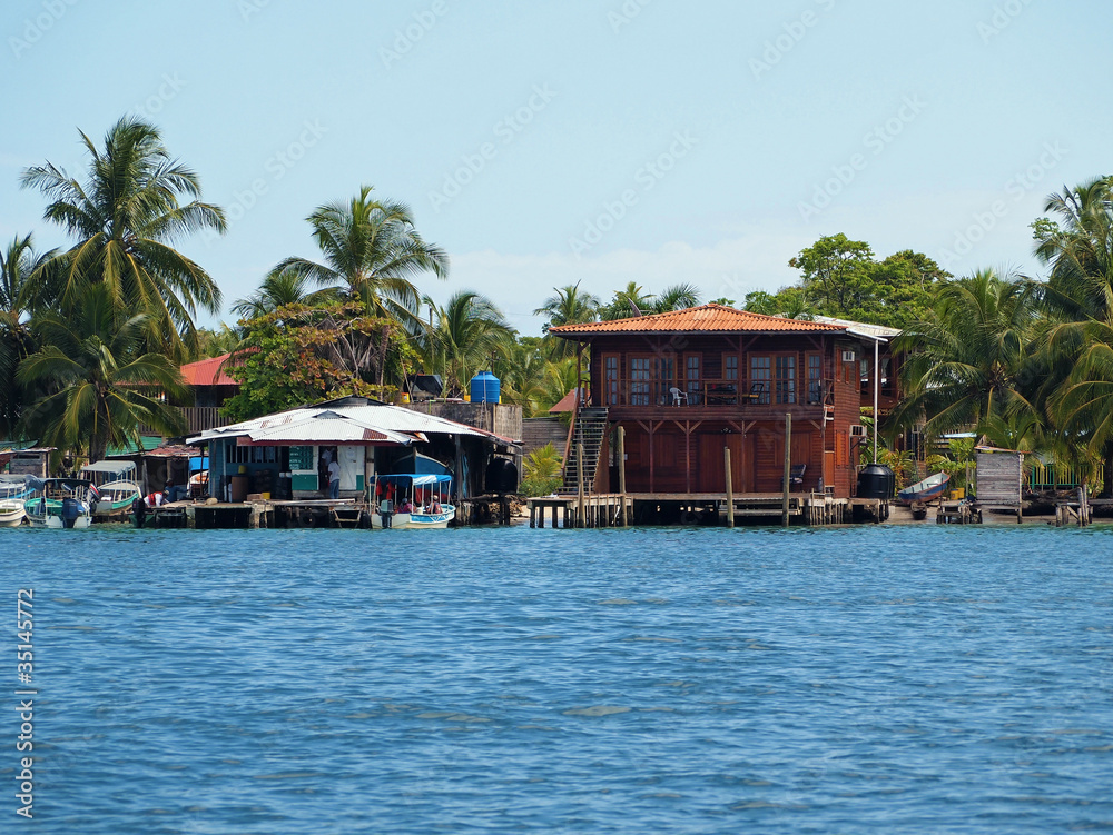 Tropical coast with a Caribbean house and a small fuel station for boats, archipelago of Bocas del Toro, Carenero island, Panama, Central America