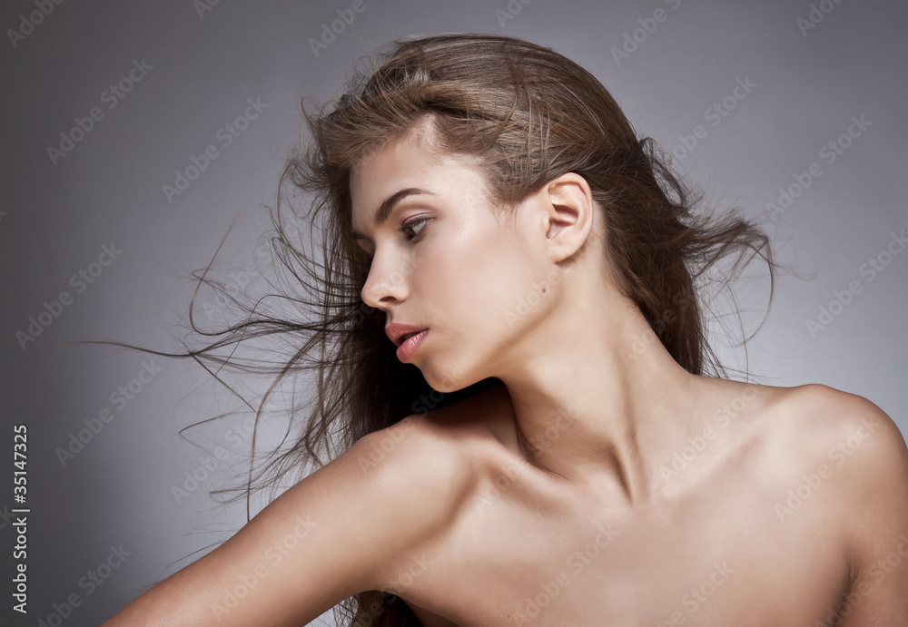Beautiful woman with fluttering hair. On dark background. Beautiful woman with fluttering hair. On dark background.