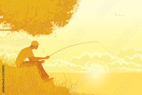 Fisherman fishing at the lake in the early autumn morning