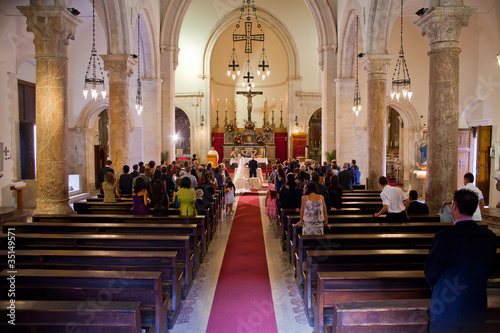 Couple getting married in a church photo