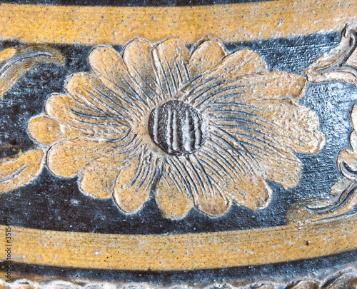Fine flower sculpture on the pottery. photo