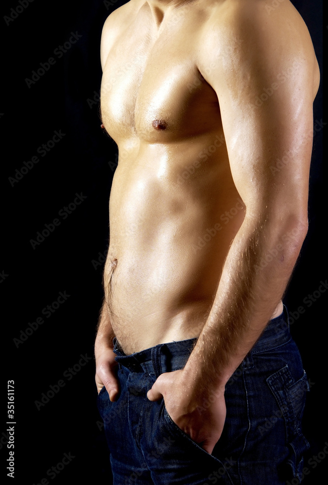 Naked muscular male model in jeans
