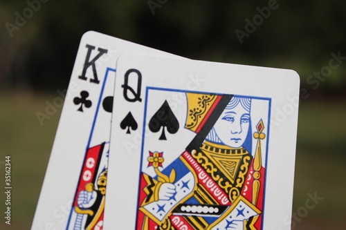 The king and the queen cards outdoor with green background