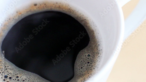 Pouring milk in the coffee close-up photo