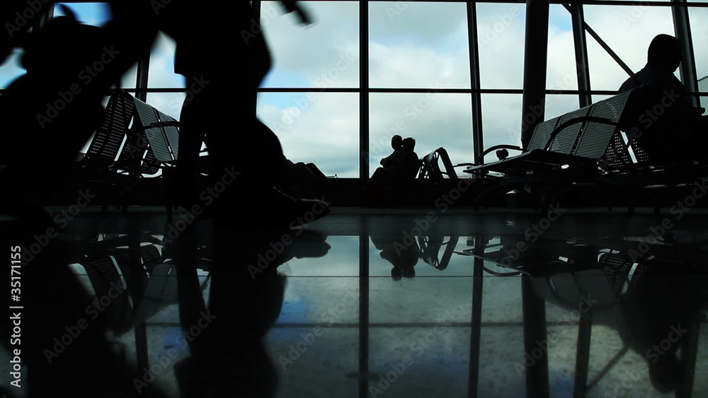 People silhouettes walking at airport space People silhouettes walking at airport space