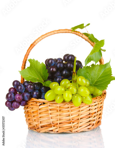 Ripe red grapes in basket isolated on white