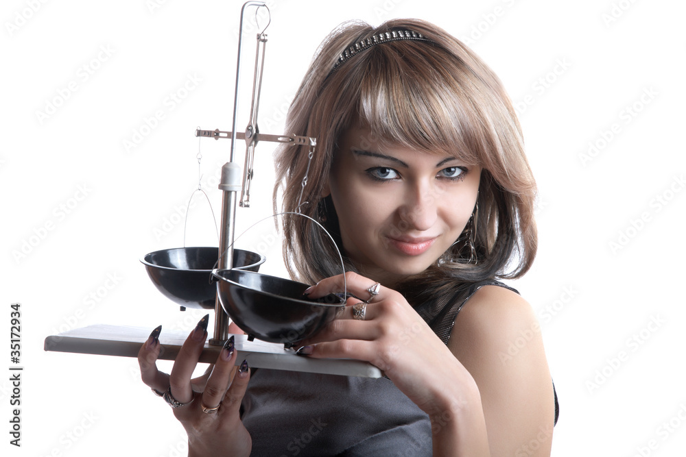 The girl with pharmaceutical scales in hands The girl with pharmaceutical scales in hands