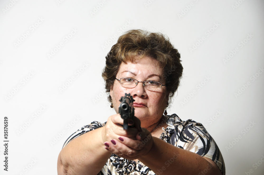 a 60 year old Hispanic woman pointing a gun in self defense. a 60 year old Hispanic woman pointing a gun in self defense.