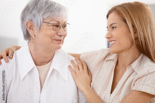 Young woman hugging mother smiling