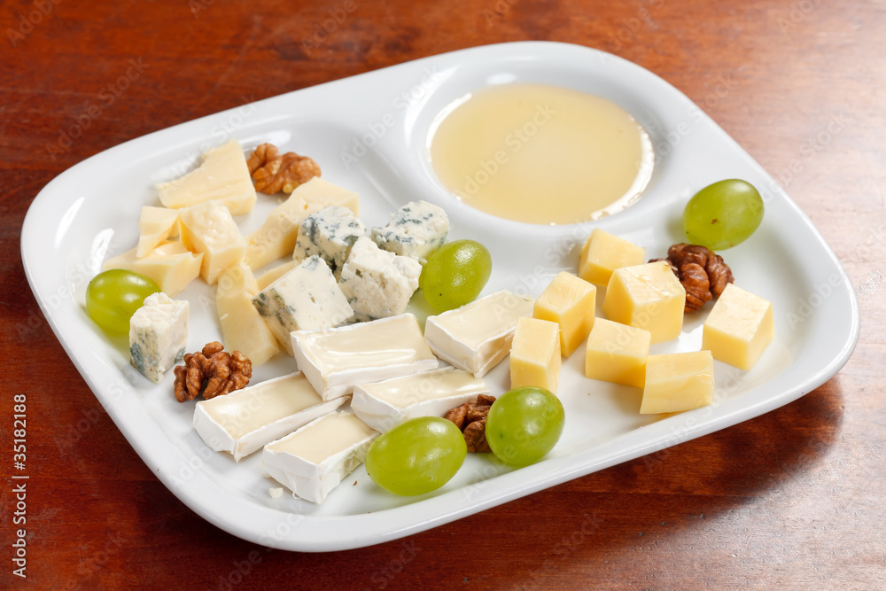 Cheese plate with grapes and honey Cheese plate with grapes and honey