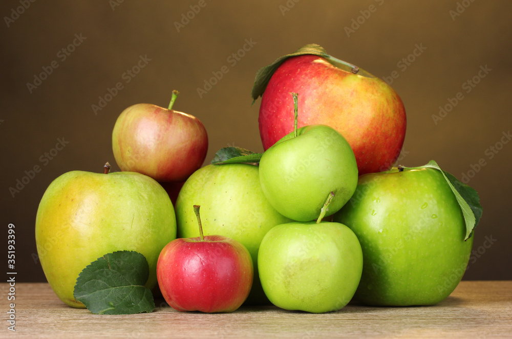 Many fresh organic apples on wooden table on yellow background Many fresh organic apples on wooden table on yellow background