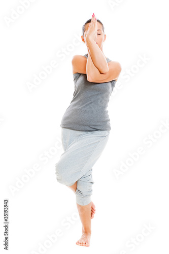 young yoga female doing yogatic exercise photo