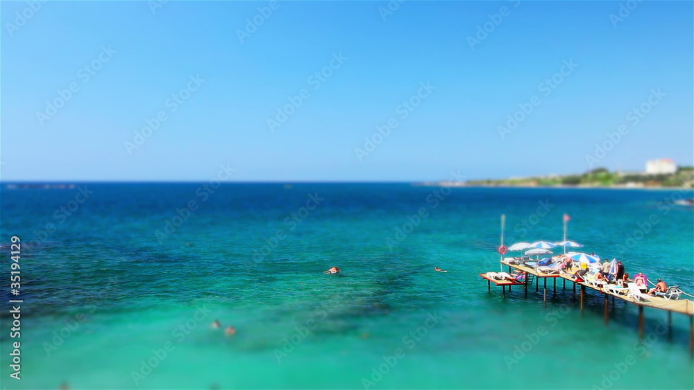 A view of bridge over sea from a high angle. Tilt shift effect