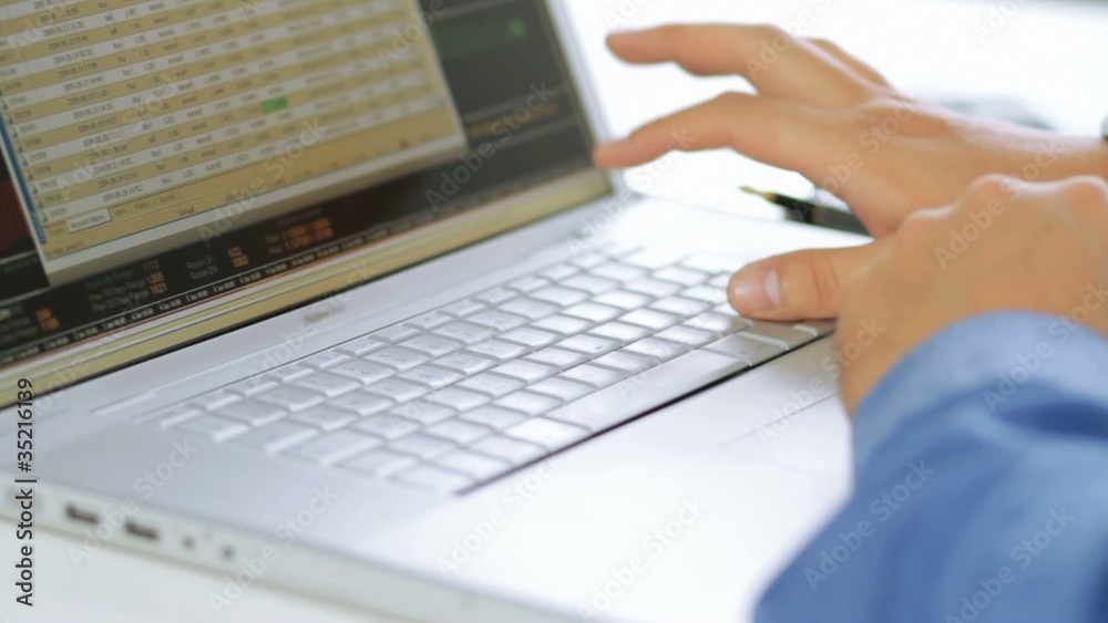 Businessman using calculator and laptop computer Businessman using calculator and laptop computer