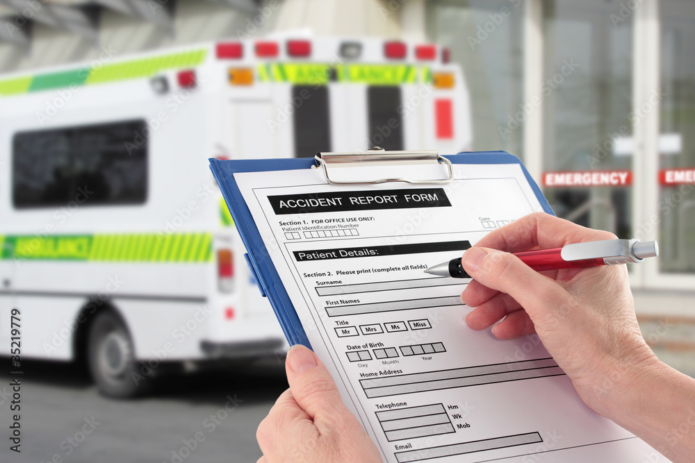 Hand Completing an Accident Report Form by Ambulance Hand Completing an Accident Report Form by Ambulance