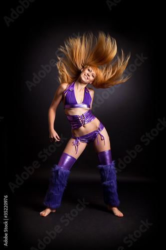 Young woman dancing with flowing hair