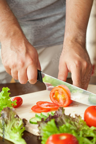 man cutting vegetables