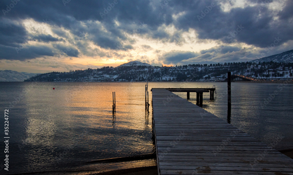 scenic dock on mountain lake at sunset