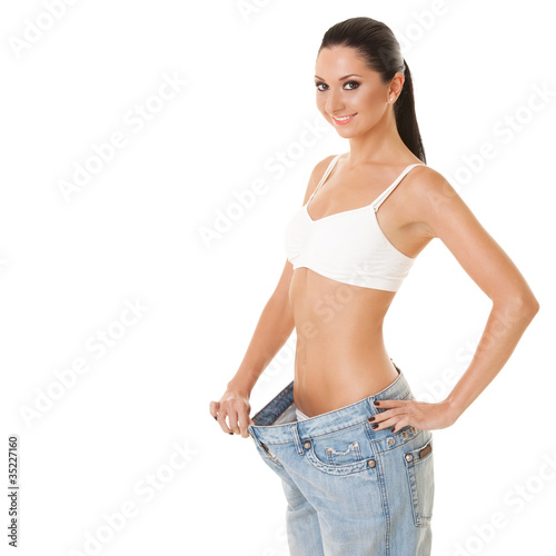 Pretty woman shows her weight loss by wearing an old jeans © Dmytro Sunagatov
