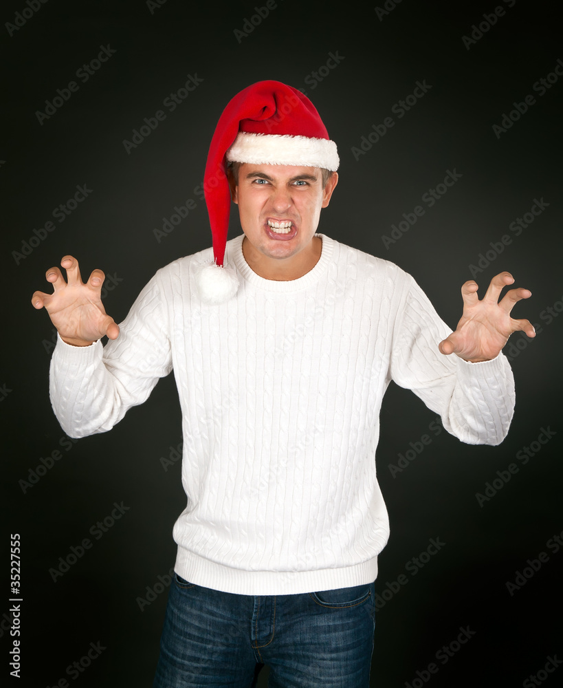 Fototapeta premium man in the bell Santa's face shows terrible