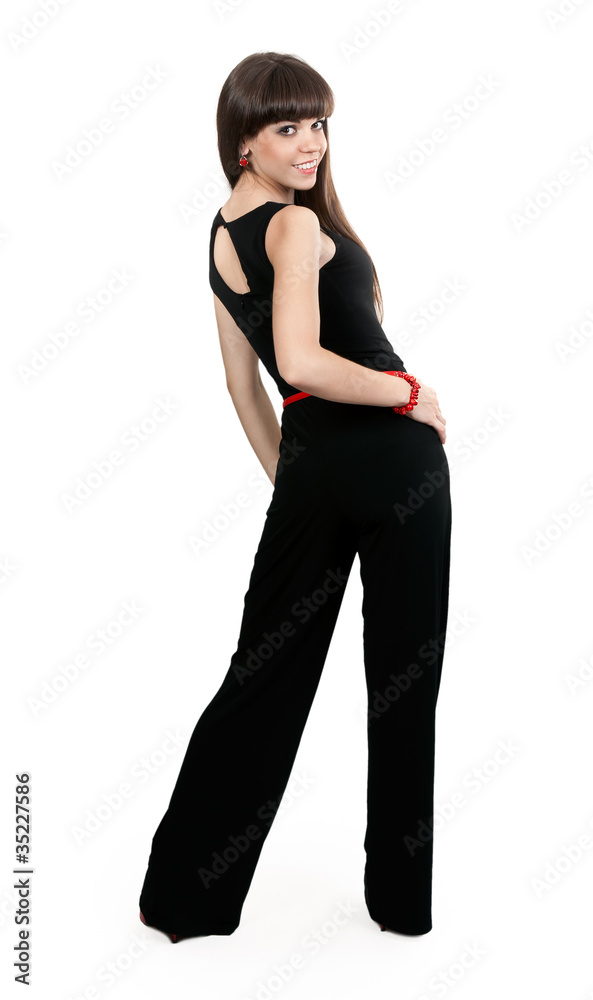 Fototapeta premium beautiful girl in pants looks from behind the studio