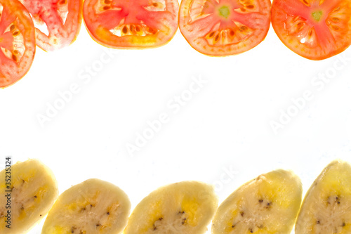 Pieces of sliced tomato and banana frame