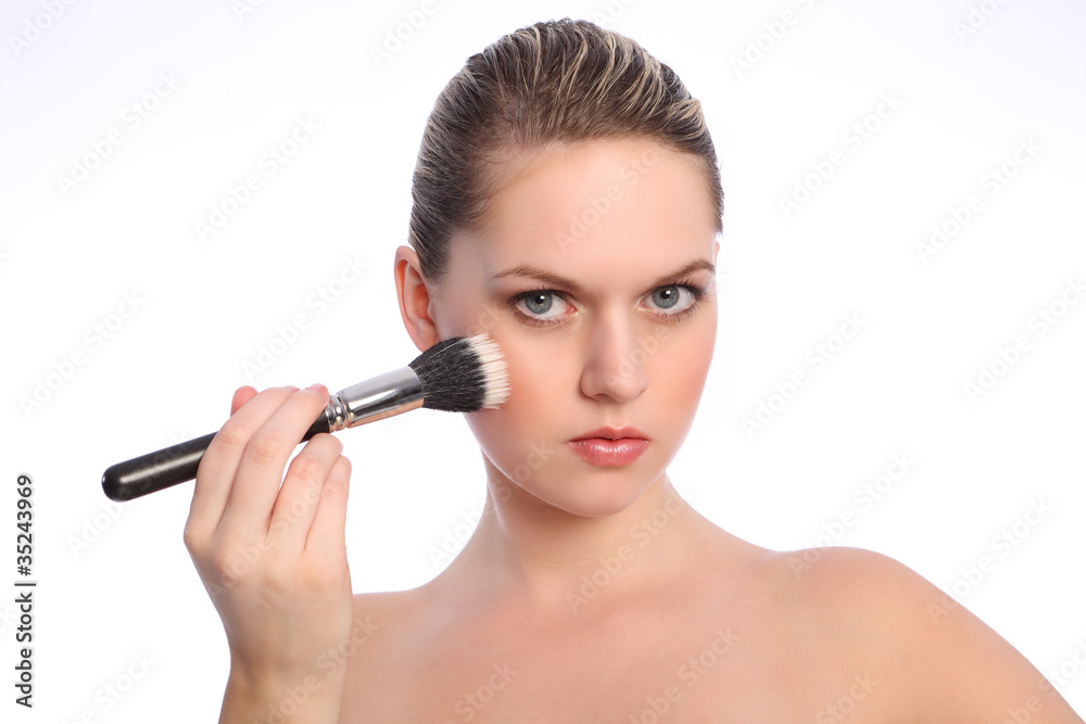 Beautiful woman using stippling make up brush Beautiful woman using stippling make up brush