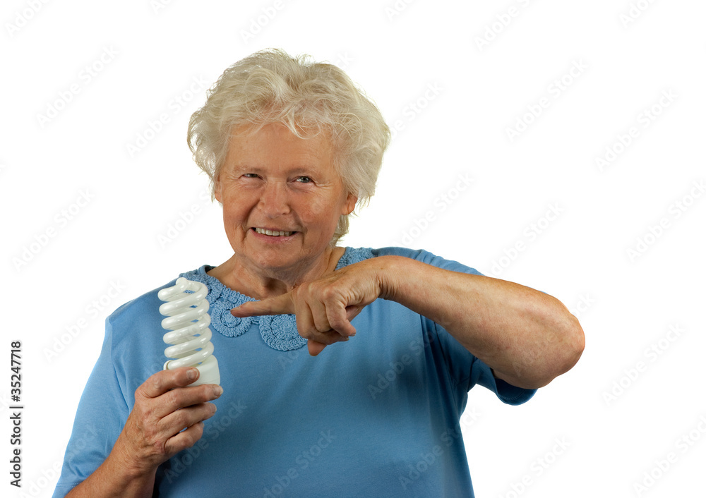 senior woman is pointing to a energy efficient light senior woman is pointing to a energy efficient light