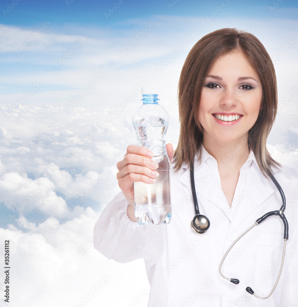 Young attractive female doctor over sky background Young attractive female doctor over sky background