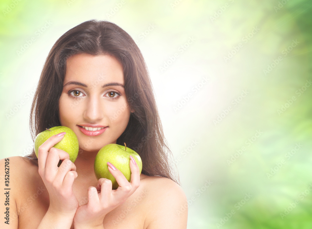 A young and beautiful brunette woman with apples A young and beautiful brunette woman with apples