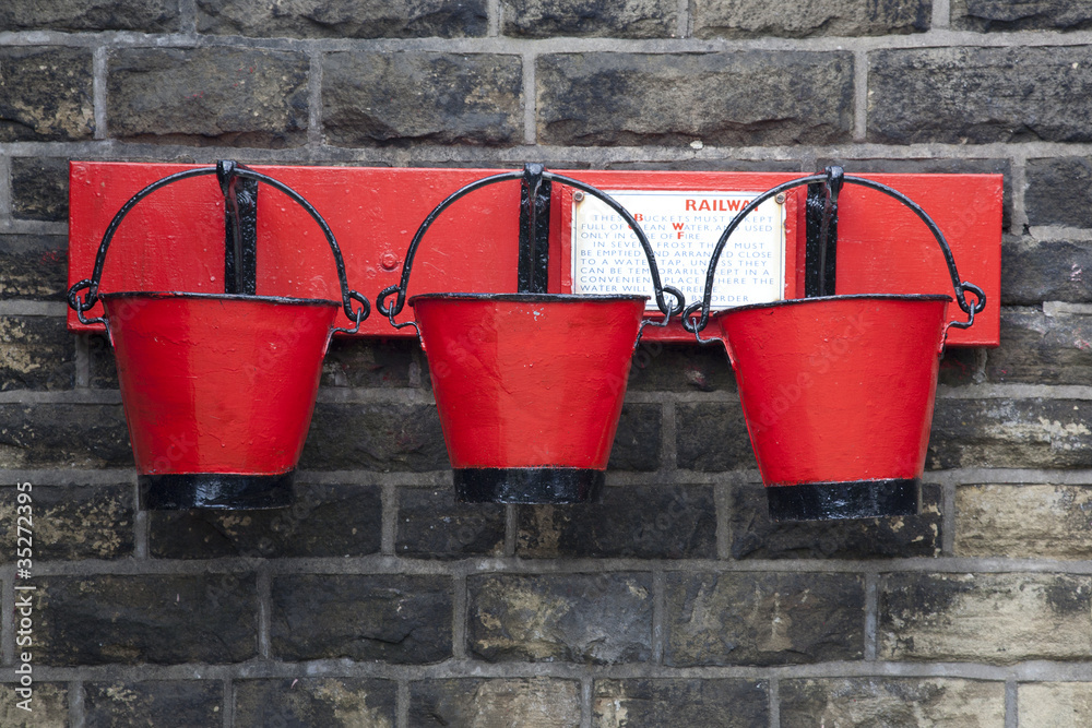 Three Old Red Fire Buckets at a Railway Station Three Old Red Fire Buckets at a Railway Station