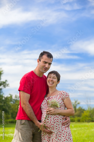 Husband hugs his pregnant wife