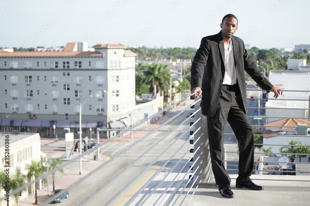 Businessman posing by the ledge