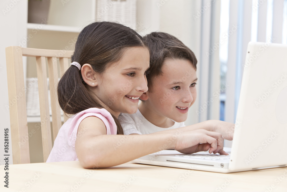 Boy & Girl Children Using Laptop Computer at Home Boy & Girl Children Using Laptop Computer at Home