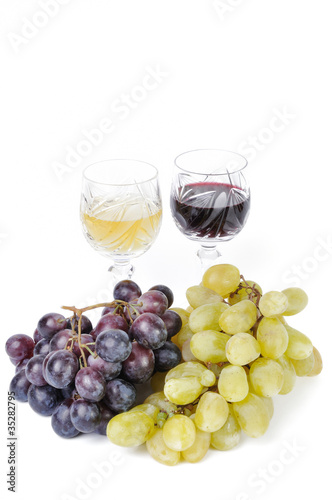 Glasses of wine with grapes isolated in white