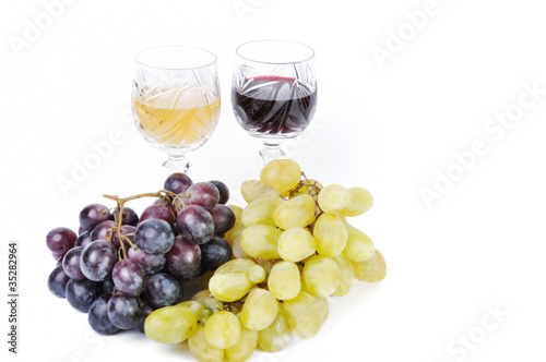 Glasses of wine with grapes isolated in white