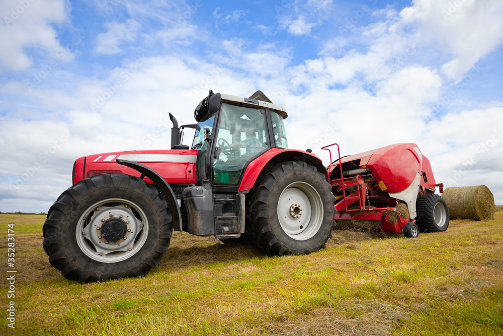 tractor collecting haystack in the field tractor collecting haystack in the field