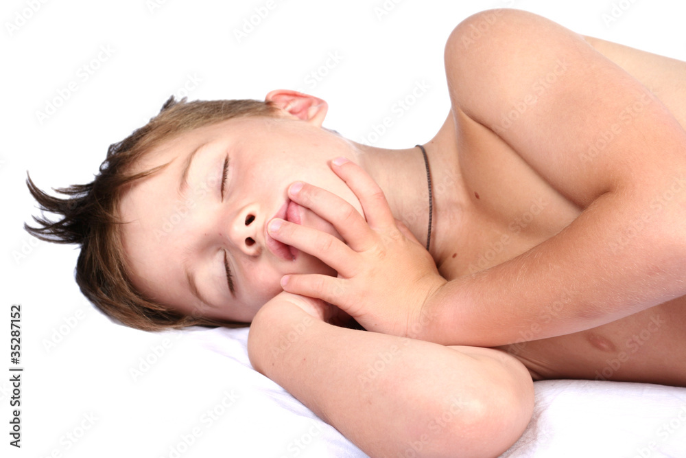 The boy strong sleeps on a white background The boy strong sleeps on a white background