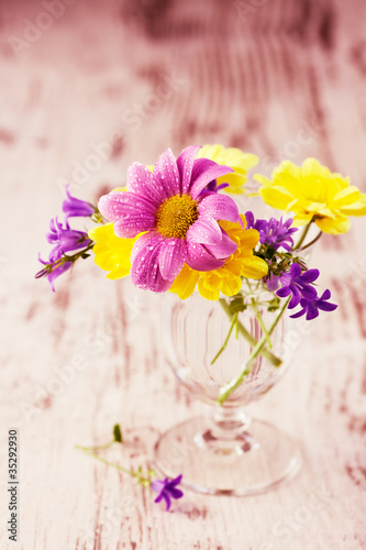 Spring flowers in a wineglass
