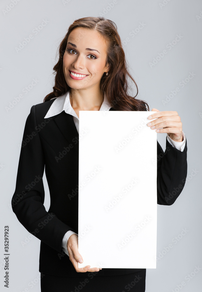 Businesswoman showing signboard, over grey Businesswoman showing signboard, over grey