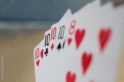 Poker hand - Four of a kind, with beach background